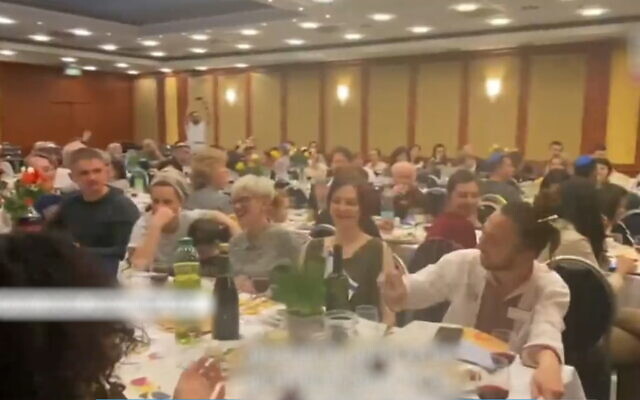 Ukrainian Jews are hosted by the Jewish Agency for a Passover seder in Warsaw, Poland, on April 15, 2022. (Screenshot/Channel 12 news)