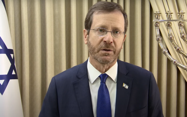 President Isaac Herzog's records a special Passover greeting to world Jewry, April 14, 2022. (Screen grab/YouTube/GPO)