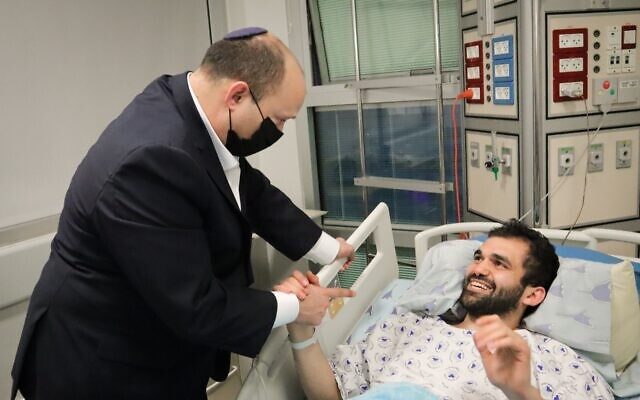 Prime Minister Naftali Bennett visits vctims from a terror shooting in Tel Aviv, at Ichilov hospital, on April 9, 2022. (Courtesy)