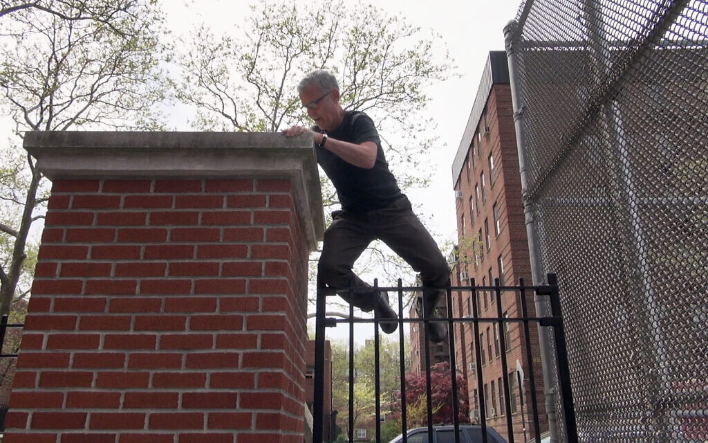 Filmmaker Jay Rosenblatt climbing over the gate at PS 194 in Brooklyn, NY, where he was a student in the 1960s. (Courtesy of HBO)