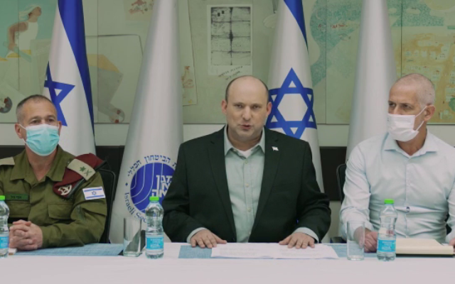 Prime Minister Naftali Bennett (C) speaks in a video statement before a meeting with Shin Bet chief Ronen Bar (R), his military secretary Avi Gil and other security officials, on April 2, 2022. (Screen capture/YouTube) Prime Minister Naftali Bennett (C) speaks in a video statement before a meeting with Shin Bet chief Ronen Bar (R), his military secretary Avi Gil and other security officials, on April 2, 2022. (Screen capture/YouTube)