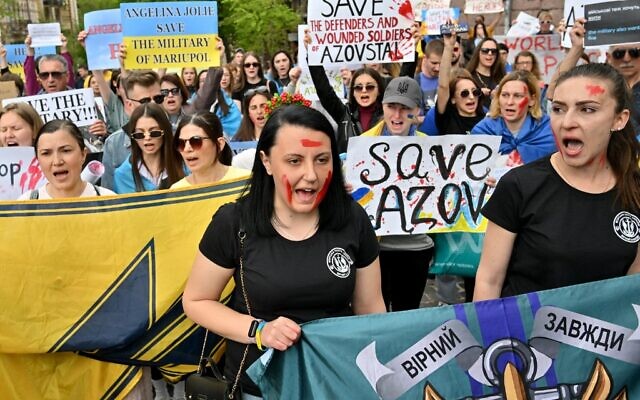 People and relatives of Azov battalion servicemen's currently engaged in defending the Azovstal plant, shout slogans during a rally called, 'Save military of Mariupol,' in front of the Ukrainian President Volodymyr Zelensky's office in Kyiv on May 3, 2022. (Sergei SUPINSKY/ AFP)