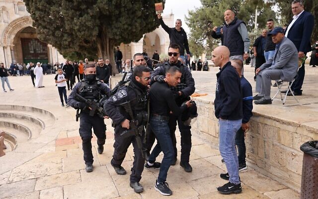 Israeli police restrain a Palestinian amid clashes at the Temple Mount on May 5, 2022, as the Jerusalem holy site was reopened to non-Muslim visitors. (Ahmad Gharabli/AFP)