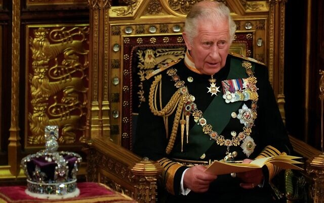 Britain's Prince Charles reads the Queen's Speech as he sits by the Imperial State Crown, in the House of Lords chamber, during the State Opening of Parliament, at the Houses of Parliament, in London, on May 10, 2022. (Alastair Grant / POOL / AFP)