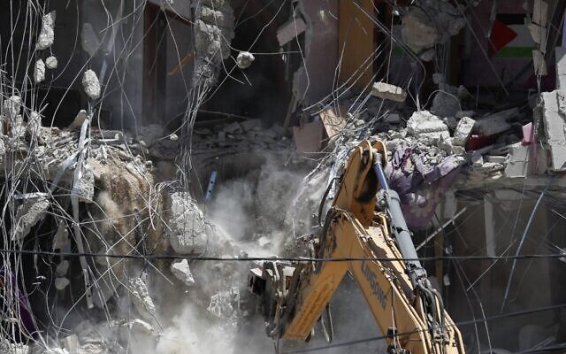 Illustrative: Israeli machinery demolishes a Palestinian house in the East Jerusalem neighborhood of Silwan on May 10, 2022. (Ahmad GHARABLI / AFP)