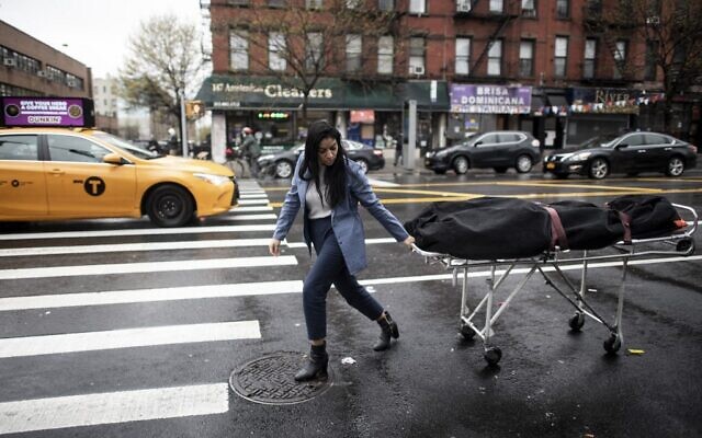 A funeral service manager transports a body to the funeral home in the Harlem neighborhood of New York City,  April 24, 2020. (Johannes EISELE / AFP)