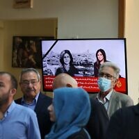 People gather at the Al Jazeera offices in the West Bank city of Ramallah on May 11, 2022 following the killing of veteran journalist Shireen Abu Akleh who was shot as she covered an Israeli raid on the West Bank's Jenin refugee camp. (ABBAS MOMANI / AFP)