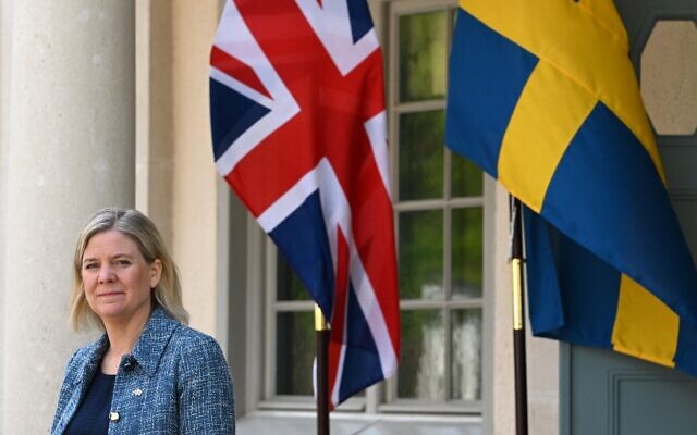 Sweden's Prime Minister Magdalena Andersson stands next to the British and the Swedish flags as she waits for the arrival of British Prime Minister Boris Johnson for talks in Harpsund, 120 kilometers west of Stockholm, Sweden on May 11, 2022. (Jonathan Nackstrand/AFP)