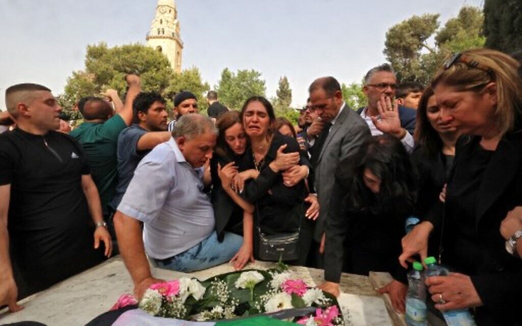 Mourners gather during the burial of slain veteran Al Jazeera journalist Shireen Abu Akleh at the Mount Zion Cemetery outside Jerusalem's Old City on May 13, 2022. (HAZEM BADER/AFP)