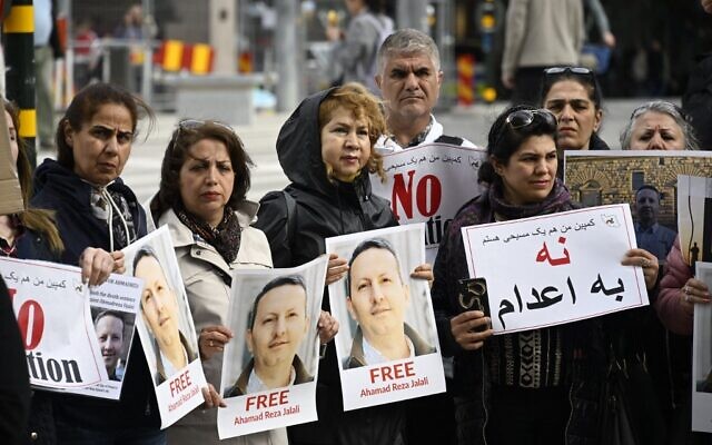 Demonstrators hold posters with a portrait of Swedish-Iranian doctor and researcher Ahmadreza Djalali (Ahmad Reza Jalali) who is imprisoned and sentenced to death in Iran, during a protest claiming to free him, on May 14, 2022 in Stockholm, Sweden. (Anders WIKLUND / TT News Agency / AFP) / Sweden OUT