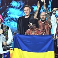 Members of the band 'Kalush Orchestra' celebrate onstage with Ukraine's flags after winning on behalf of Ukraine the Eurovision Song contest 2022 on May 14, 2022 at the Pala Alpitour venue in Turin. (Marco BERTORELLO / AFP)