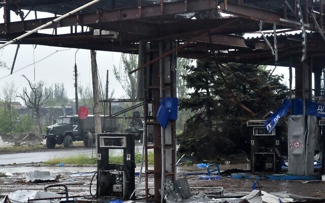 A Russian military truck painted with the letter Z is seen behind a destroyed gas station in Ukraine's port city of Mariupol on May 18, 2022. (Olga MALTSEVA / AFP)