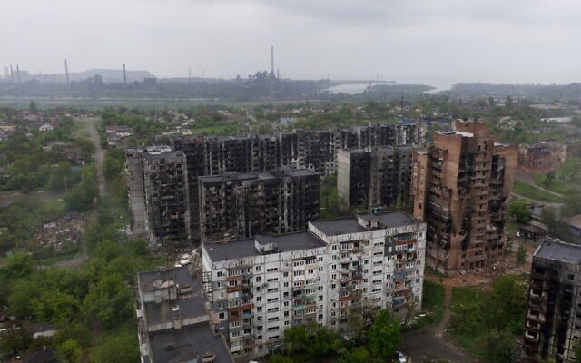 An aerial view of damaged residential buildings and the Azovstal steel plant in the background in the port city of Mariupol, Ukraine, on May 18, 2022. (Andrey BORODULIN / AFP)