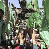 A Palestinian student in a Hamas shirt is tossed in the air during a rally supporting the group as they celebrate a victory in student elections at Birzeit University on the outskirts of Ramallah on May 19, 2022. (ABBAS MOMANI / AFP)