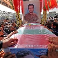 Mourners gather around the coffin of Iran's Revolutionary Guards colonel Sayyad Khodaei during a funeral procession at Imam Hussein square in the capital Tehran, on May 24, 2022. (ATTA KENARE / AFP)