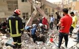 Iranians rescuers scour the rubble at the site where a ten-story building collapsed, as rescue operations continue in the southwestern city of Abadan on May 24, 2022.  (Tasnim News/AFP)