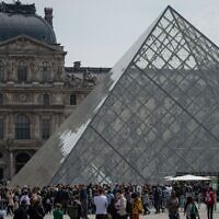 Visitors outside the Louvre Museum, in Paris on April 29, 2022. (AFP)