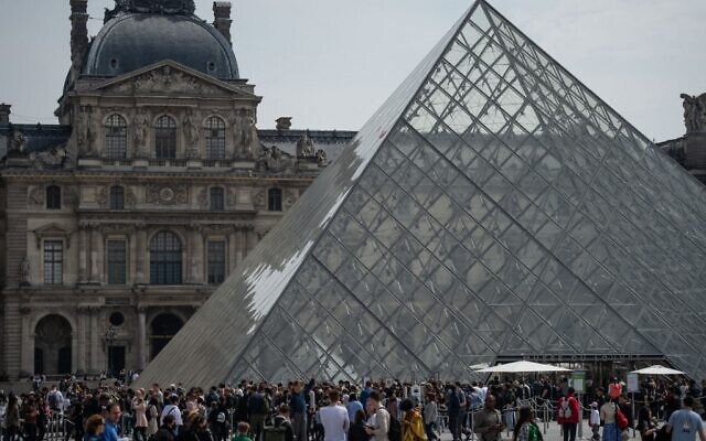 Visitors outside the Louvre Museum, in Paris on April 29, 2022. (AFP)