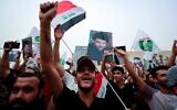 Supporters of Iraqi Shiite cleric Muqtada al-Sadr gather in Baghdad's Tahrir Square on May 26, 2022, to celebrate the passing of a bill that criminalizes normalization of ties with Israel. (Ahmad Al-Rubaye/AFP)