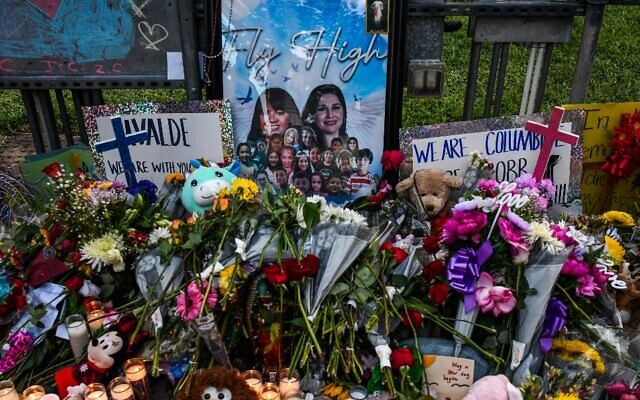 Flowers, candles and pictures are pictured at a makeshift memorial outside the Uvalde County Courthouse in Texas on May 28, 2022. (Chandan Khanna/AFP)