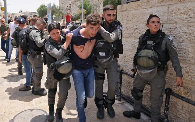 Israeli security forces detain a Palestinian at the Damascus Gate to Jerusalem's Old City amid Jerusalem Day celebrations on May 29, 2022. (Ahmad Gharabli/AFP)