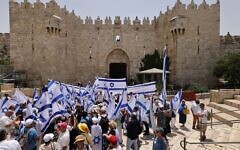 Israelis wave the national flag at the Damascus Gate to the Old City Jerusalem's as they mark Jerusalem Day, on May 29, 2022. - (AHMAD GHARABLI / AFP)