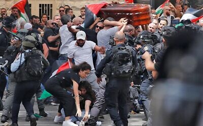 Violence erupts between Israeli security forces and Palestinian mourners carrying the casket of Al Jazeera journalist Shireen Abu Akleh out of a hospital, before being transported to a church and then her resting place, in Jerusalem, on May 13, 2022. (Ahmad GHARABLI / AFP)