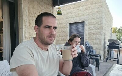 A picture uploaded by Tekoa resident Yair Maimon to Facebook on May 9, shows him and his wife drinking coffee outside their home alongside the caption, 'Waiting for the next terrorist.' (Facebook)