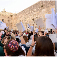 Women hold a prayer service at the Western Wall as demonstrators protest against them on May 2, 2022. (Women of the Wall)