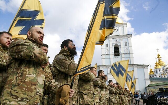 Ukrainian volunteers with the right-wing paramilitary Azov National Corps with their flags demonstrate their strength, during Ukrainian Volunteer Day in Kyiv, Ukraine, March 14, 2020. (AP Photo/Efrem Lukatsky)