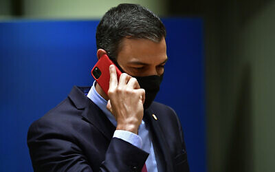 Spain's Prime Minister Pedro Sanchez speaks on his cellphone during a round table meeting at an EU summit in Brussels, July 20, 2020. (John Thys, Pool Photo via AP)