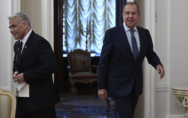 Russian Foreign Minister Sergey Lavrov, right, and Israeli Foreign Minister Yair Lapid enter a hall for talks in Moscow, Russia, Thursday, Sept. 9, 2021. (Alexander Nemenov/Pool Photo via AP)