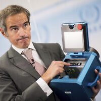 Director General of the International Atomic Energy Agency, IAEA, Rafael Mariano Grossi shows the inner of a case of an IAEA monitoring device during a press conference in Vienna, Austria, Friday, Dec. 17, 2021. (AP/Michael Gruber)