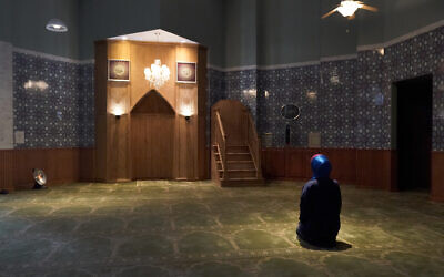 Madinah Javed sits in a prayer room at the American Islamic College in Chicago for her afternoon prayer, January 27, 2022. (AP/Charles Rex Arbogast)