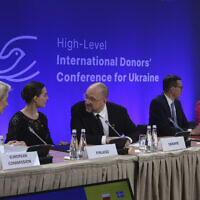 Ukrainian Prime Minister Denys Szmyhal, center, talks to President of the European Commission Ursula von der Leyen, left, and Prime Minister of Finland, Sanna Marin, 2nd left, at the High-Level International Donor's Conference for Ukraine at the National Stadium in Warsaw, Poland, on May 5, 2022. (AP Photo/Michal Dyjuk)