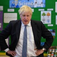 Britain's Prime Minister Boris Johnson visits the Field End Infant school, in South Ruislip, London, on May 6, 2022, following the local government elections. (Daniel Leal/Pool via AP)