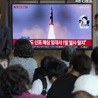 People watch a TV showing a file image of North Korea's missile launch during a news program at the Seoul Railway Station in Seoul, South Korea, on May 7, 2022. (AP Photo/Ahn Young-joon)