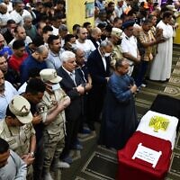 Men pray in front of the coffin of military solider Ahmed Mohamed Ahmed Ali, who was killed in battle, during his funeral service, in Qalyubia province, Egypt, May 8, 2022. At least 11 Egyptian troops, including an officer, were killed May 7, 2022 in a militant attack on a water pumping station east of the Suez Canal, the military said. (AP Photo/Sayed Hassan)