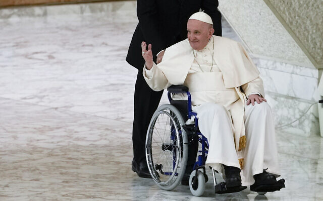 Pope Francis arrives in a wheelchair to attend an audience with nuns and religious superiors in the Paul VI Hall at The Vatican, May 5, 2022. (AP Photo/ Alessandra Tarantino, File)