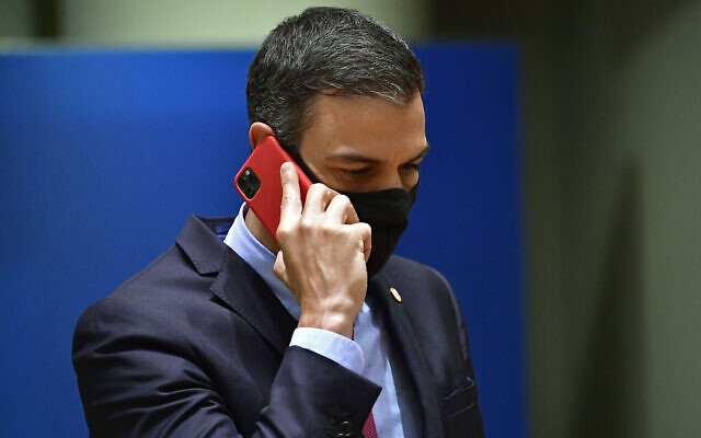 Spain's Prime Minister Pedro Sanchez speaks on his cell phone during a round table meeting at an EU summit in Brussels, on July 20, 2020.  (John Thys, Pool Photo via AP, File)