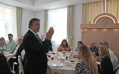 Rabbi Elie Abadie says a blessing as he hosts a lunch for a Jewish business delegation at a villa that serves as a temporary synagogue for his congregation in Dubai, United Arab Emirates, May 10, 2022. (AP Photo/Kamran Jebreili)