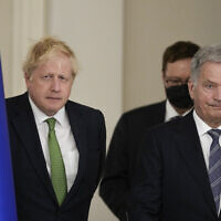 British Prime Minister Boris Johnson, left, and Finland's President Sauli Niinisto arrive to meet the media, at the Presidential Palace in Helsinki, Finland, May 11, 2022. (AP Photo/Frank Augstein, Pool)