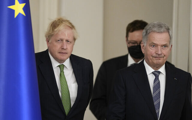 British Prime Minister Boris Johnson, left, and Finland's President Sauli Niinisto arrive to meet the media, at the Presidential Palace in Helsinki, Finland, May 11, 2022. (AP Photo/Frank Augstein, Pool)