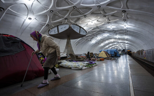 An elderly woman walks inside a metro station being used as a bomb shelter in Kharkiv, Ukraine, on May 12, 2022. (AP Photo/Mstyslav Chernov)