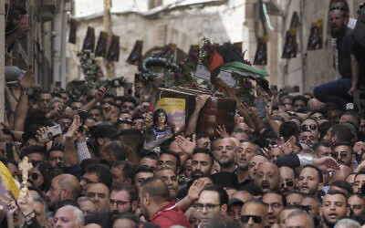 Mourners carry the casket of slain Al Jazeera veteran journalist Shireen Abu Akleh during her funeral in Jerusalem's Old City, May 13, 2022. (AP Photo/Mahmoud Illean)