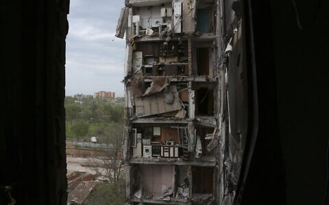 Parts of apartments are seen at the side of damaged during a heavy fighting buildings in Mariupol, in territory under the government of the Donetsk People's Republic, eastern Ukraine, May 13, 2022. (AP)