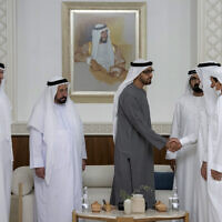 This photo from Ministry of Presidential Affairs shows Sheikh Mohamed bin Zayed Al Nahyan, President of the United Arab Emirates and Ruler of the Emirate of Abu Dhabi, 4th left, shakes hands with one of the rulers in the presence of the Sheikh Mohammed bin Rashid Al Maktoum, Vice President, Prime Minister and Ruler of Dubai, 3rd right, Dr. Sheikh Sultan bin Muhammad Al Qasimi, Supreme Council Member and Ruler of Sharjah, 3rd left, and rest of UAE rulers, as Mohamed bin Zayed accepts their condolences, May14, 2022. (Ministry of Presidential Affairs via AP/Hamad Al Kaabi)