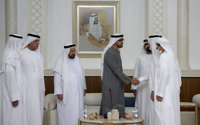 This photo from Ministry of Presidential Affairs shows Sheikh Mohamed bin Zayed Al Nahyan, President of the United Arab Emirates and Ruler of the Emirate of Abu Dhabi, 4th left, shakes hands with one of the rulers in the presence of the Sheikh Mohammed bin Rashid Al Maktoum, Vice President, Prime Minister and Ruler of Dubai, 3rd right, Dr. Sheikh Sultan bin Muhammad Al Qasimi, Supreme Council Member and Ruler of Sharjah, 3rd left, and rest of UAE rulers, as Mohamed bin Zayed accepts their condolences, May14, 2022. (Ministry of Presidential Affairs via AP/Hamad Al Kaabi)