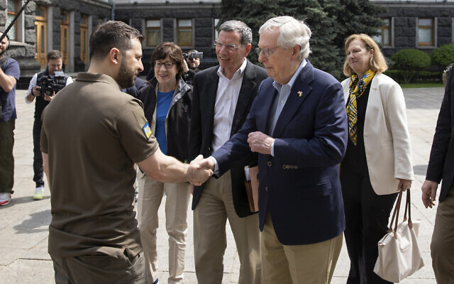 In this handout photo provided by the Ukrainian Presidential Press Office, Ukrainian President Volodymyr Zelensky, left, shakes hands with US Senate Minority Leader Mitch McConnell in Kyiv, Ukraine, May 14, 2022. (Ukrainian Presidential Press Office via AP)