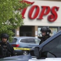Police secure a perimeter after a shooting at a supermarket, Saturday, May 14, 2022, in Buffalo, NY (AP Photo/Joshua Bessex)